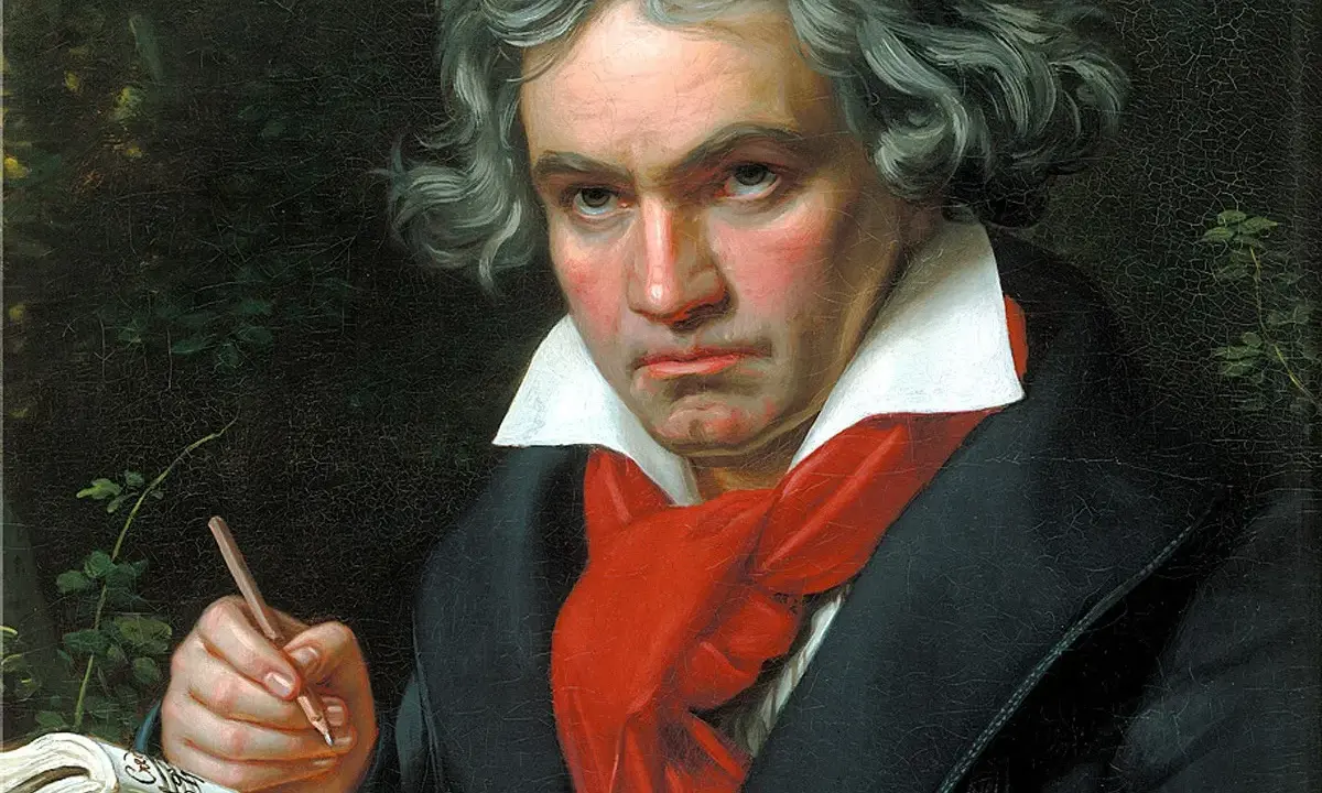 Portret Beethovena, geniusza muzyki, pochylonego nad nutami. Jego wzrok pełen pasji, a dłoń z ołówkiem gotowa do tworzenia.