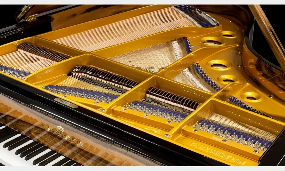 Wnętrze fortepianu z widocznymi strunami, młoteczkami i złotą ramą. Ten klawesyn instrument to dzieło sztuki.