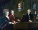 Portret rodziny Mozarta: Leopold, Wolfgang i Nannerl przy klawesynie. W tle portret Anny Marii Pertl.