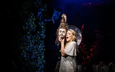 Salome, w białej sukni, trzyma odciętą głowę Jokanaana. Scena z opery Richarda Straussa, która jest jednym z jego najważniejszych utworów.
