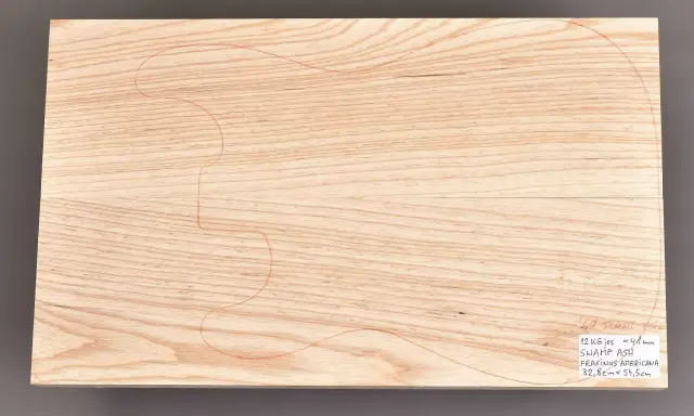 Deska z jesionu bagiennego, z nakreślonym konturem gitary. Idealny materiał na korpus instrumentu.